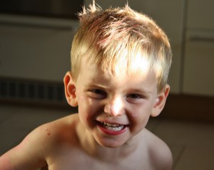 Birthday boy covered in chalk (post party)